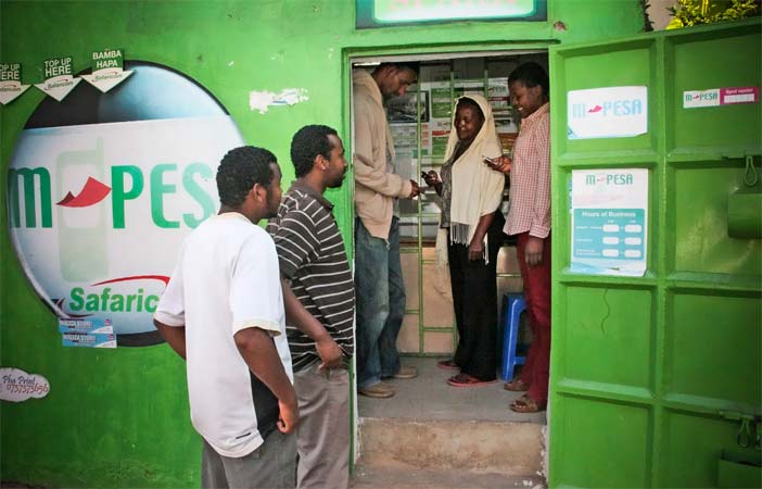 Customers make money transfers at an M-Pesa stall in Nairobi, Kenya, in 2011.