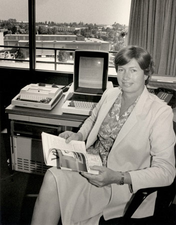 Lynn Conway holding a copy of her VLSI publication.