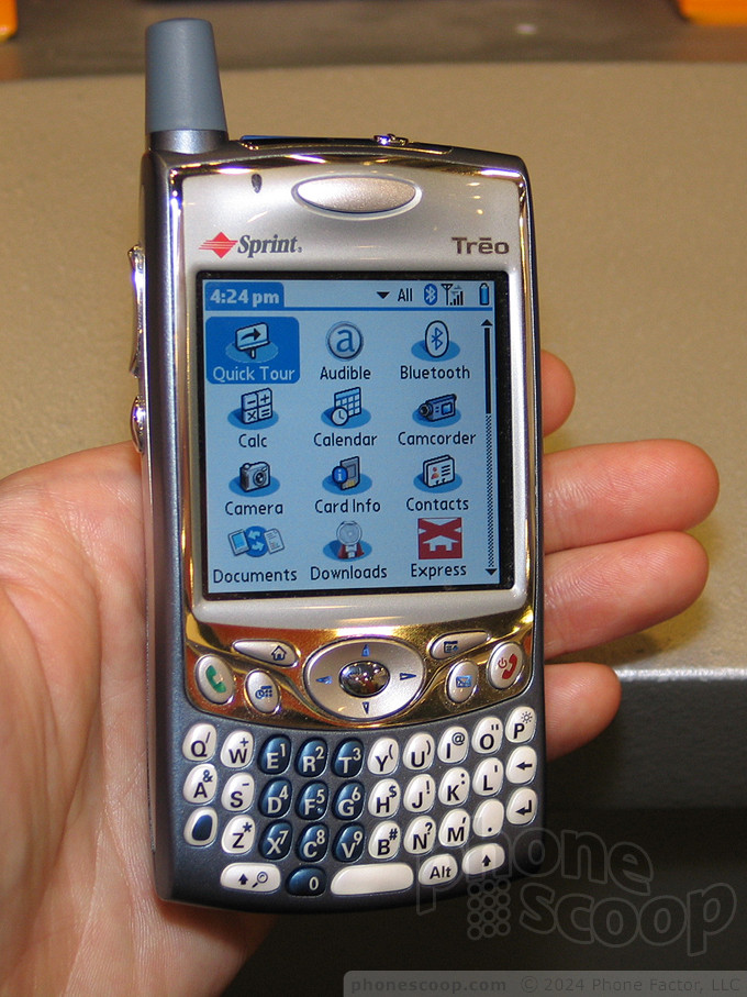 Photo of a hand holding the Treo 650 featuring the home screen settings.