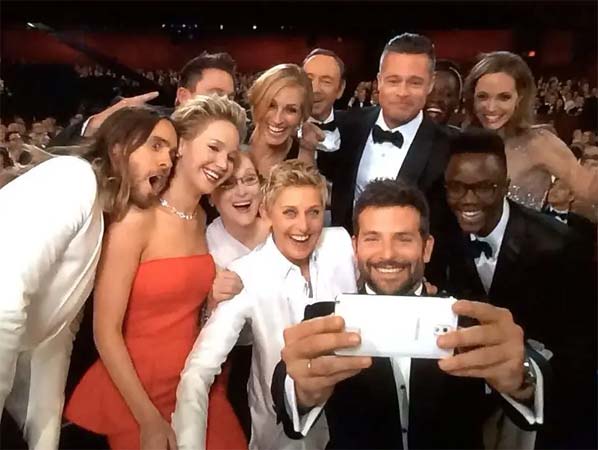 Photo of the making of the 2014 Oscar Selfie featuring Ellen Degeneres, Bradley Cooper, Jennifer Lawrence, Meryl Streep, and other stars.